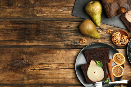 Flat lay composition with tasty pear bread on wooden table, space for text. homemade cakeの写真素材