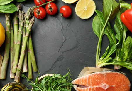 Frame made with asparagus and products on black table, flat lay. Space for textの写真素材