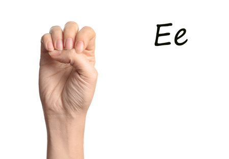 Woman showing letter E on white background, closeup. sign languageの写真素材
