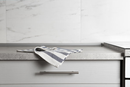 Striped cotton towel on countertop in kitchenの写真素材
