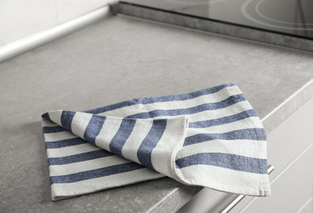 Striped cotton towel on countertop in kitchenの写真素材