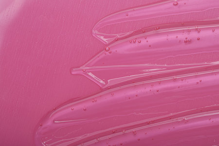Pure transparent cosmetic gel on pink background, top viewの写真素材