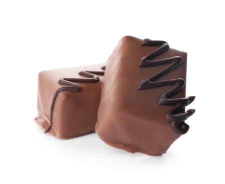 Delicious milk chocolate candies isolated on whiteの写真素材