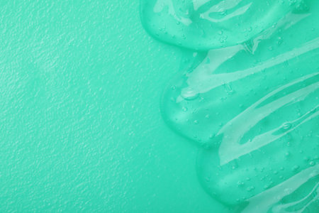 Sample of transparent cosmetic gel on turquoise background, top viewの写真素材