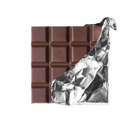 Delicious milk chocolate bar wrapped in foil isolated on whiteの写真素材