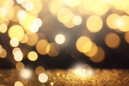 Blurred view of gold glitter on dark background, bokeh effectの写真素材