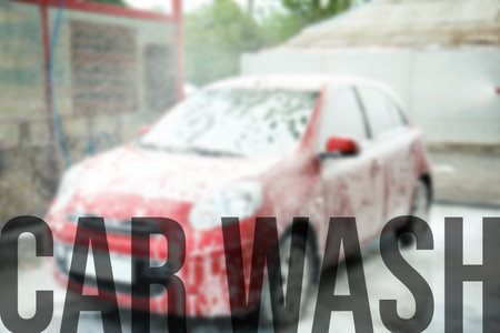 Text Car Wash and automobile covered with foam on backgroundの写真素材