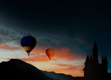 Fairy tale world. Hot air balloons flying near hideaway castle in mountainsの写真素材