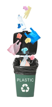 Different plastic garbage falling into trash bin. Waste management and recyclingの写真素材
