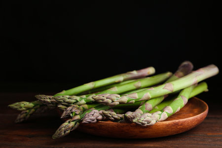 Fresh raw asparagus on wooden table, closeupの写真素材