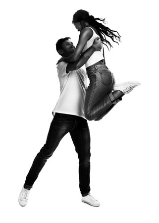 Beautiful young couple dancing on white backgroundの写真素材