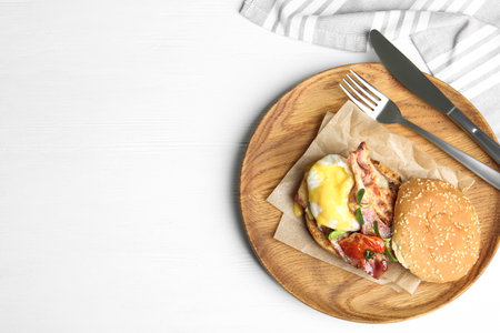 Delicious egg Benedict served on white wooden table, flat lay. Space for textの写真素材