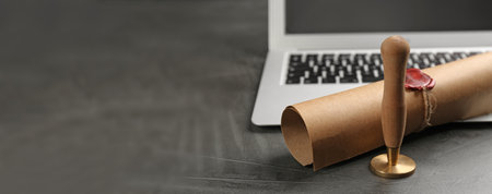 Notary's public pen and sealed document near laptop on gray stone table, space for text. banner...