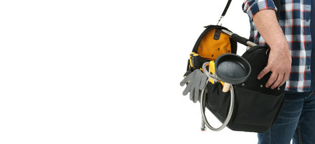Closeup view of plumber with tool bag on white background. banner designの写真素材