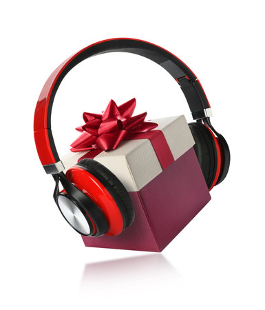 Beautiful Christmas gift box with bow and headphones on white backgroundの写真素材