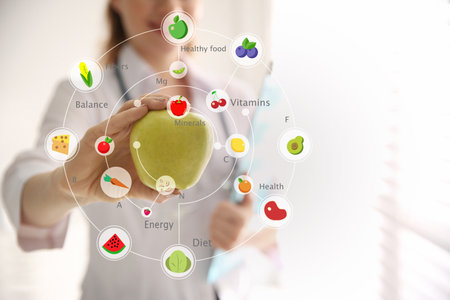 Nutritionist's recommendations. Doctor with apple in officeの写真素材