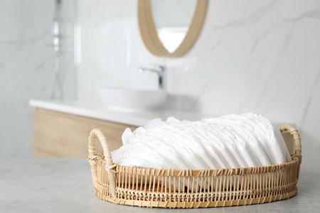 Basket with baby diapers on counter in bathroomの写真素材