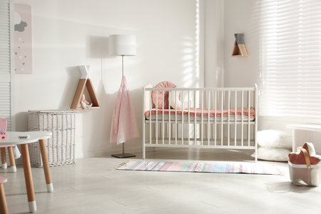 Cute baby room interior with crib and decor elementsの写真素材