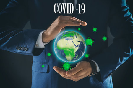 corona crash. Businessman showing planet with virus on dark background, closeupの写真素材