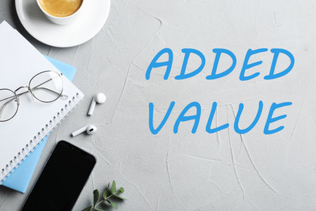 Added value concept. Flat lay composition with stationery on light backgroundの写真素材