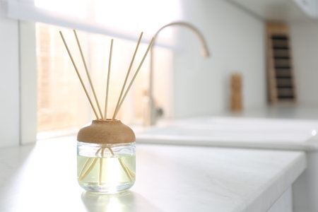 Aromatic reed air freshener on white table indoors. Space for textの写真素材