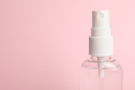 Antiseptic spray on pink background, closeup. Space for textの写真素材