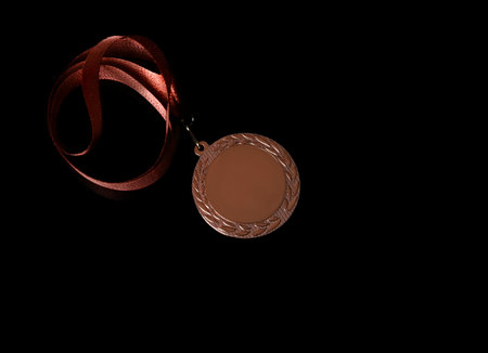 Bronze medal on black background, top view. space for designの写真素材