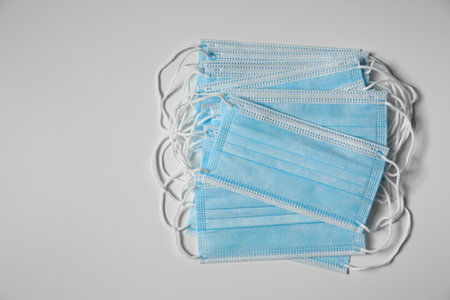 Disposable face masks on light background, flat lay.の写真素材