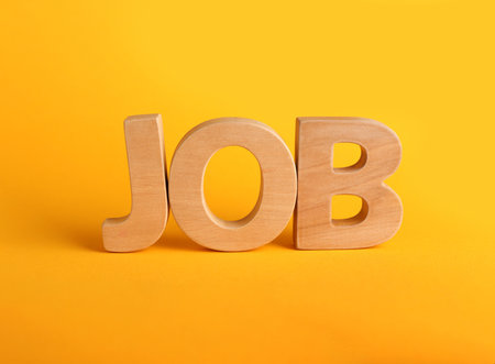 Word JOB made with wooden letters on yellow background, closeup. career conceptの写真素材
