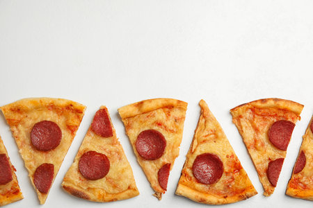 Tasty pepperoni pizza on white table, flat lay. Space for text