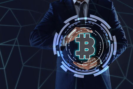 Fintech concept. Businessman demonstrating scheme with bitcoin symbolの写真素材