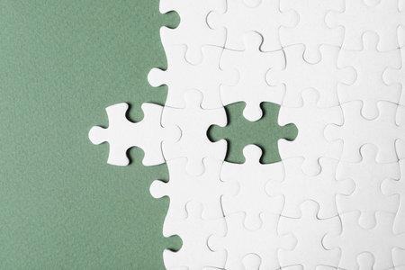 Blank white puzzle on grey background, flat layの写真素材