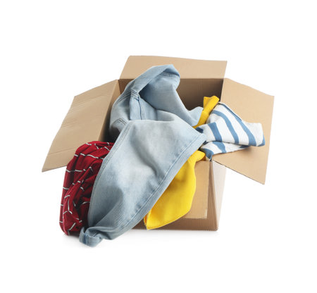 Cardboard box with clothes isolated on whiteの写真素材
