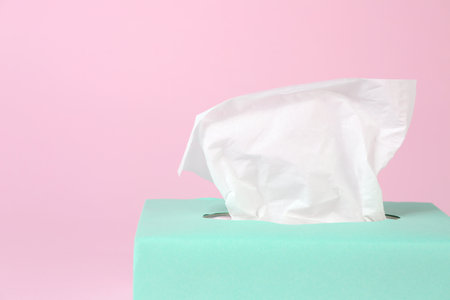 Box with paper tissues on pink background, closeupの写真素材