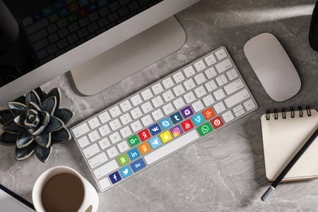 MYKOLAIV, UKRAINE - APRIL 30, 2020: Computer keyboard with social media apps logotypes on marble...