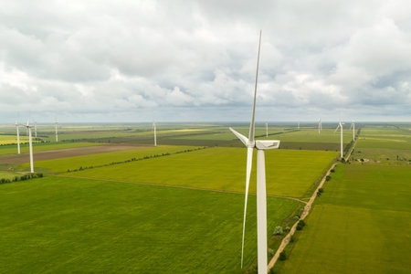 Aerial view of wind turbines in field on cloudy day