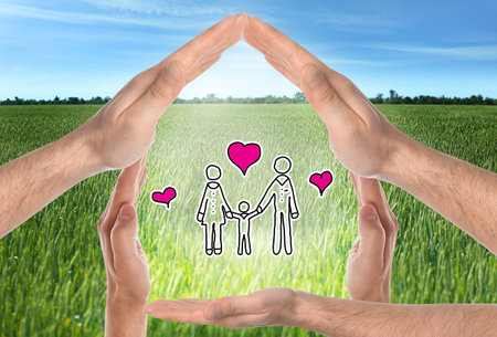 People forming house with their hands and illustration of family against beautiful landscape, closeupの写真素材