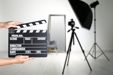 Assistant holding clapperboard on filming location, closeup. Cinema productionの写真素材