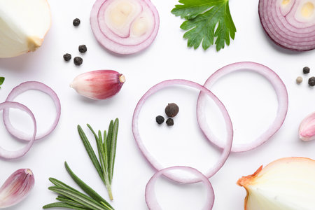 Flat lay composition with cut onion and spices on white backgroundの写真素材