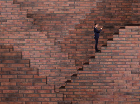 Man standing on stairs and looking at wrist watch. Way to successの写真素材