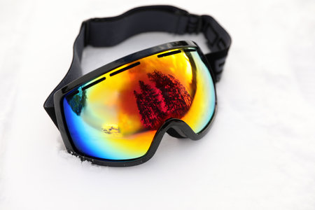 Stylish ski goggles on snow outdoors. winter sport equipmentの写真素材