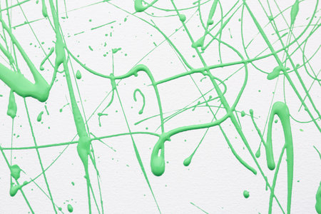 Green paint splashes on white canvas as background. Art and creativityの写真素材