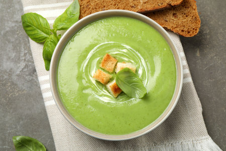Tasty homemade zucchini cream soup served on gray table, flat layの写真素材