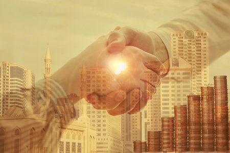 Multiple exposure of partners shaking hands, stacked coins and cityscape, closeup. business corporationの写真素材