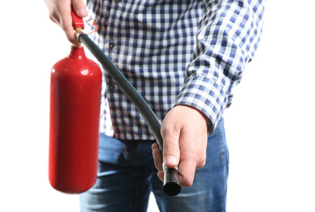 Man using fire extinguisher on white background, closeupの写真素材