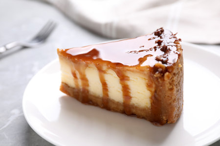 Piece of delicious cake with caramel on table, closeupの写真素材