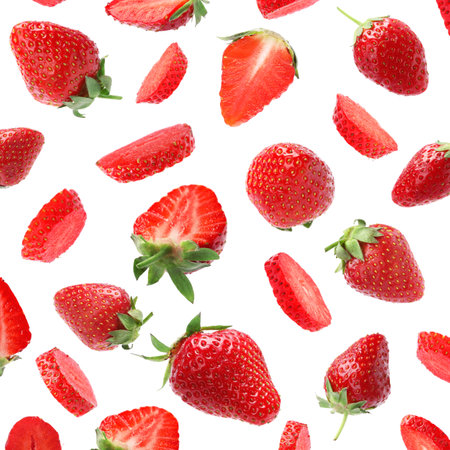 Set with ripe strawberries falling on white backgroundの写真素材