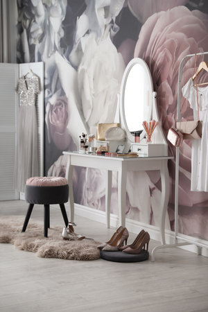 Stylish room interior with elegant dressing table and floral wallpaperの写真素材