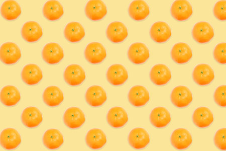Pattern of tangerines on pale orange backgroundの写真素材