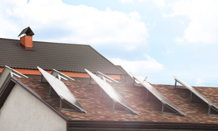 Building with installed solar panels on the roof. alternative energy sources
